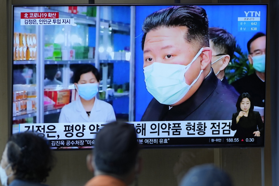 People watch a TV screen showing a news program reporting with an image of North Korean leader Kim Jong Un, at a train station in Seoul, South Korea, Monday, May 16, 2022. Kim blasted officials over slow medicine deliveries and ordered his military to respond to the surging but largely undiagnosed COVID-19 crisis that has left 1.2 million people ill with fever and 50 dead in a matter of days, state media said Monday.