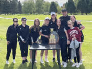 Woodland girls golf team poses with the 2A district trophy after their victory on Tuesday, May 17, 2022 at Mint Valley Golf Course in Longview.
