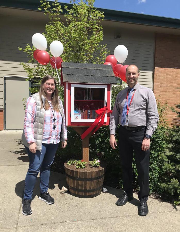 Cape Horn-Skye Elementary School teacher Darcy Hickey (left) and principal Brian Amundson attended a ribbon-cutting ceremony to celebrate the debut of the school's new little free library on May 1.