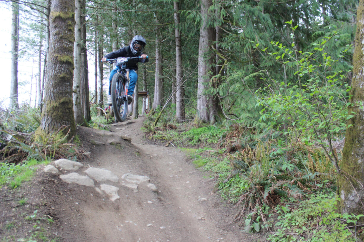 A youth division competitor in the Whatcom World Cup catches air shortly after embarking down the SST trail on Bellingham???s Galbraith Mountain.