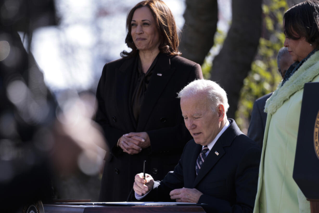 President Joe Biden signs H.R. 55, the "Emmett Till Antilynching Act," alongside Vice President Kamala Harris at an event in the Rose Garden of the White House on Tuesday, March 29, 2022, in Washington, D.C.