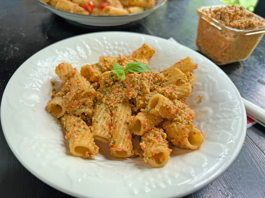 Pesto made with fresh tomatoes, lots of Parmesan and olive oil flavored with chili peppers makes for an easy pasta sauce in summer.