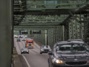 A truck joins other traffic as they cross the Interstate 5 Bridge while traveling north on I-5.