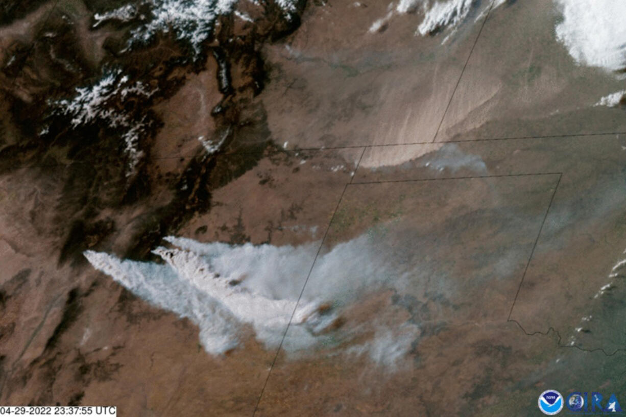 Wildfire smoke blows eastward from the mountains of New Mexico as a sandstorm sweeps down from eastern Colorado in this April 29, 2022, NOAA satellite image.