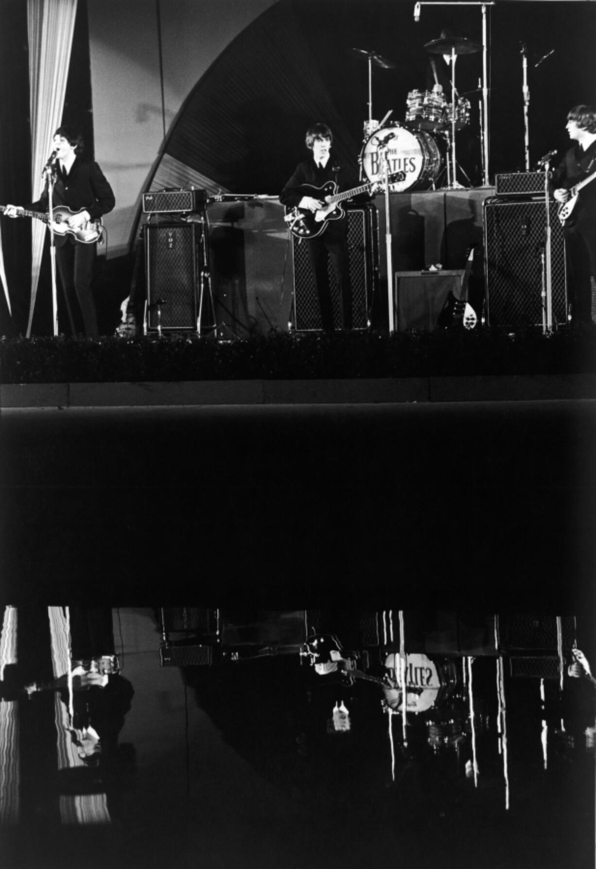 British pop group The Beatles, and their reflection, playing live at the Hollywood Bowl on Aug. 23, 1964, in Los Angeles.