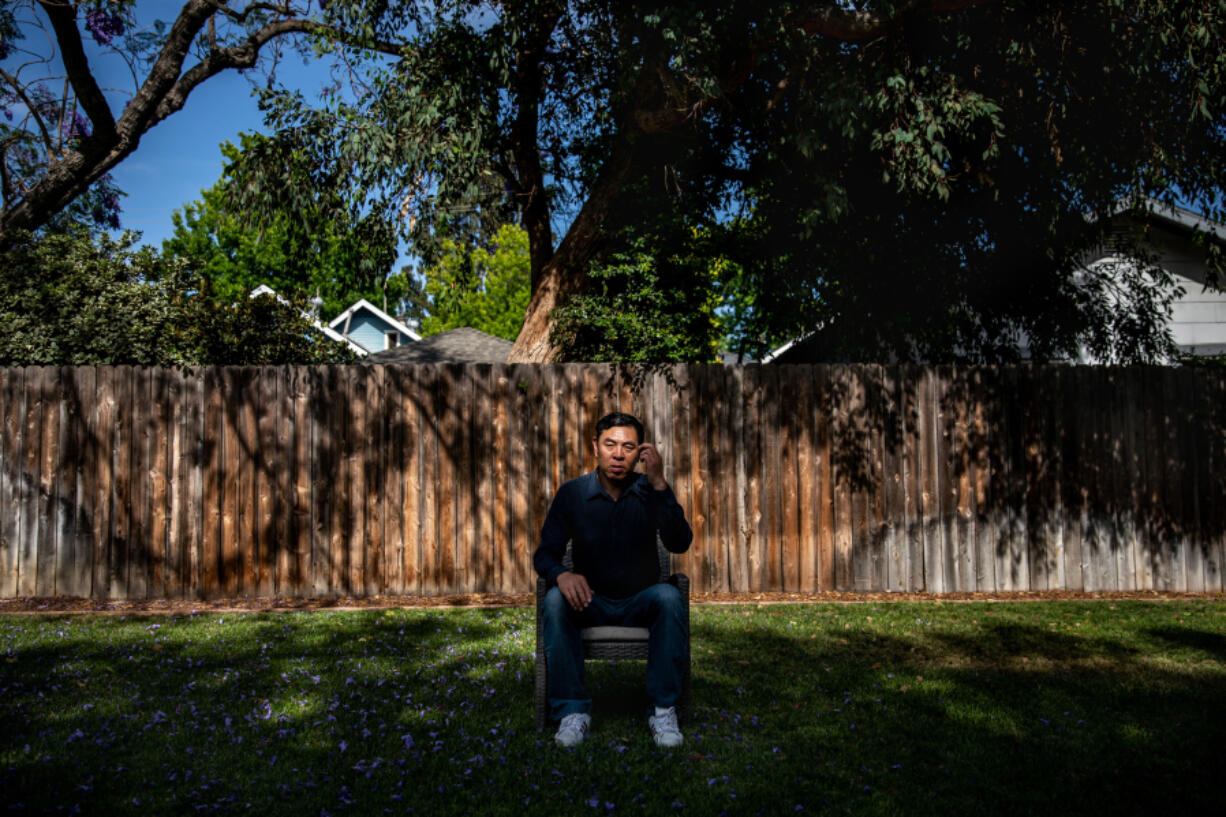 Hualun Wang, father of Peng "Aaron" Wang, a cinematography grad student at Chapman University, killed while making a student film, is photographed wearing his son's shoes, in the backyard of a home owned by Chapman University, in Orange, California, Friday, June 3, 2022. (Jay L.