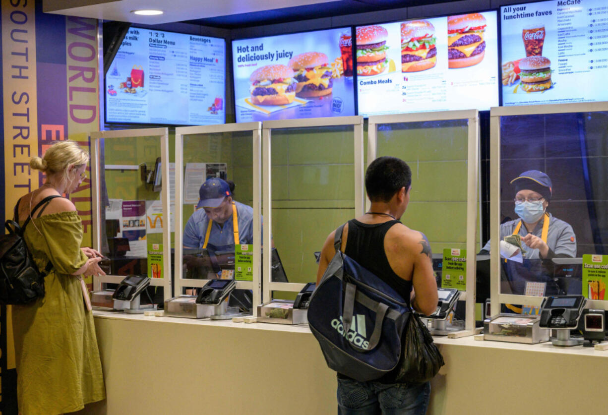 Employees serve customers May 27 at a McDonald's fast food restaurant in New York.