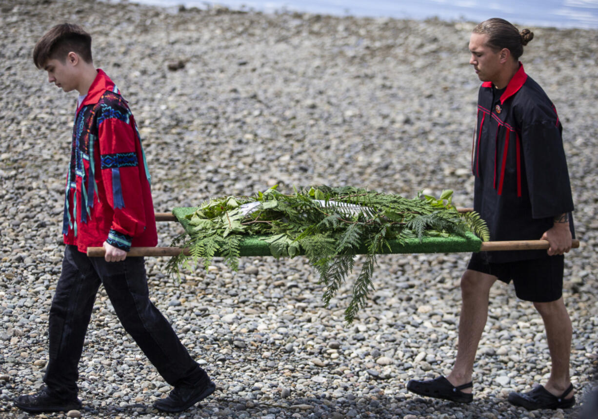 A king salmon is carried to the longhouse for Salmon Ceremony on June 11 in Tulalip.