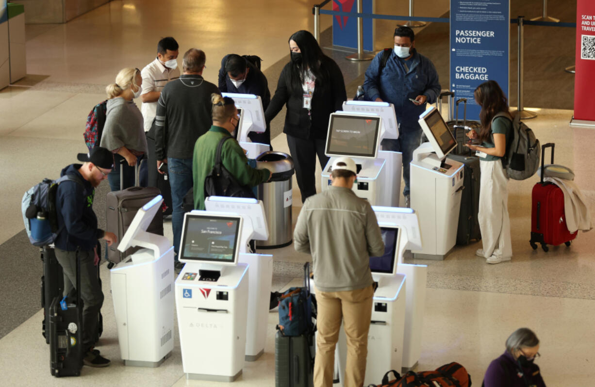 Delta Airlines customers check in for flights at San Francisco International Airport on May 12, 2022, in San Francisco, California.