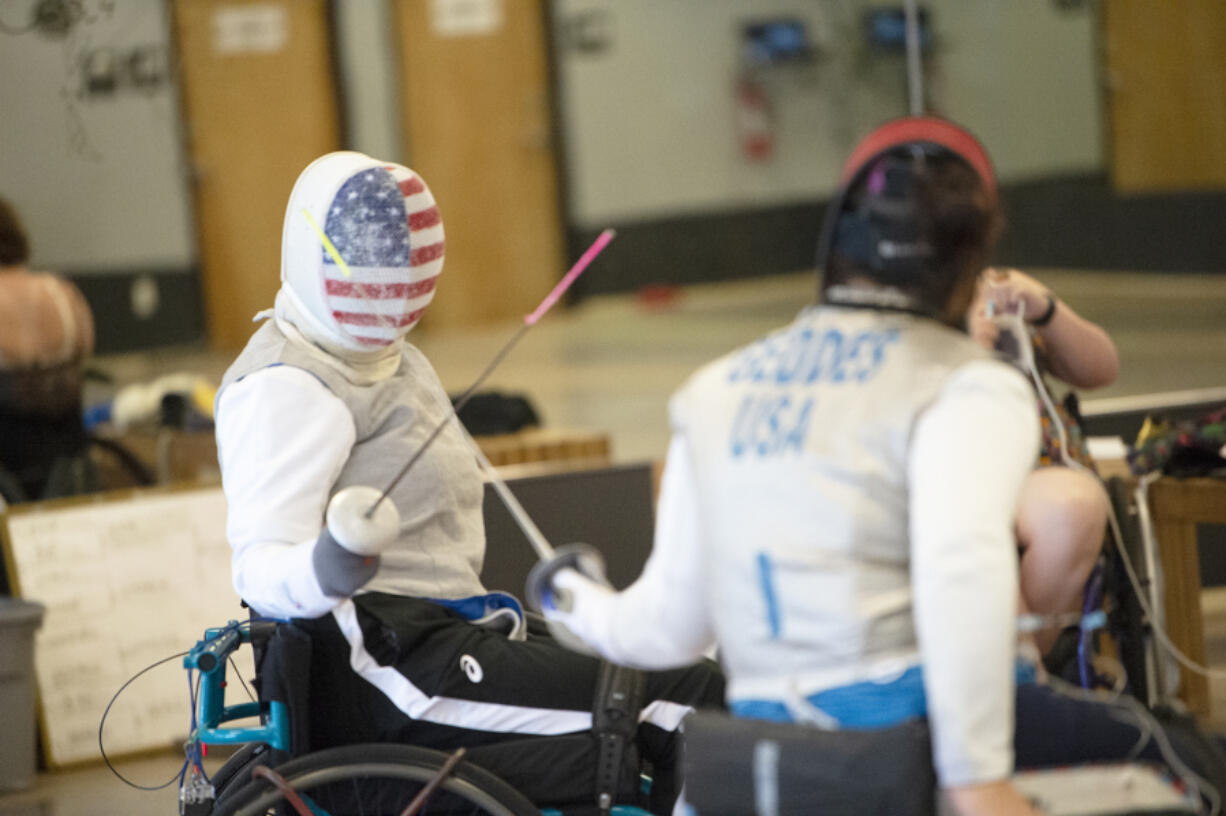 Julie Grant of Seattle, left, competes with Ellen Geddes of Aiken, S.C., during a minicamp for the U.S. parafencing team at Orion Fencing in Orchards.