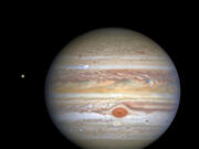 This 2020 image from NASA's Hubble Space Telescope shows Jupiter and one of its moons, Europa, at left, when the planet was 406 million miles from Earth.