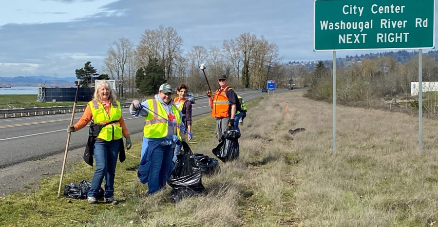 From left: Camas and Washougal residents Brenda Hatton, Lynne Lyne, Wendi Moose and John Meier pose for a photograph while picking up trash alongside state Highway 14 on March 23.