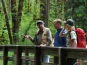 U.S. Forest Service wildlife biologist John Jakubowski, left, discusses relocating beaver to the Woods Creek area with fellow biologist Erik White from the Cowlitz Indian Tribe and USFS public affairs specialist Alexandra Pengelly.