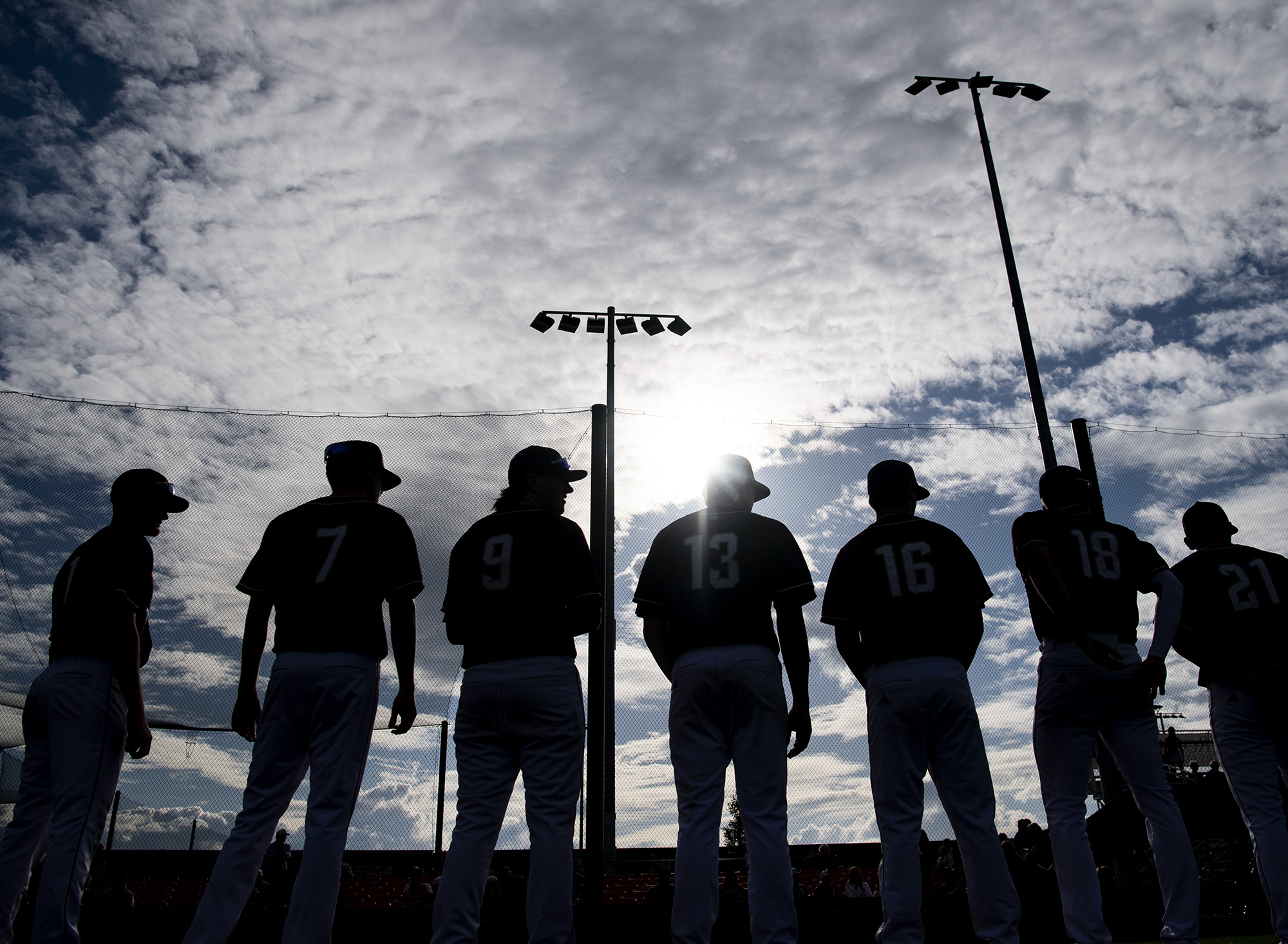 Partly cloudy skies hang above Ridgefield Raptors players Wednesday, June 1, 2022, during introductions before an exhibition game between the Ridgefield Raptors and the Cowlitz Black Bears at the Ridgefield Outdoor Recreation Complex.