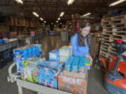 Molly Evjen, Share's director of volunteers and community resources, reviews donations dropped off at Share's Fromhold Service Center at 2306 N.E. Andresen Road as the organization's annual Appeal for Meals campaign kicked off Thursday.