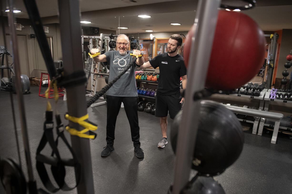 Harold Rubin of Vancouver works out with the help of personal trainer Nathan Brown at Northwest Personal Training on Monday afternoon. Northwest Personal Training bought the building it has been leasing for 22 years in downtown Vancouver.
