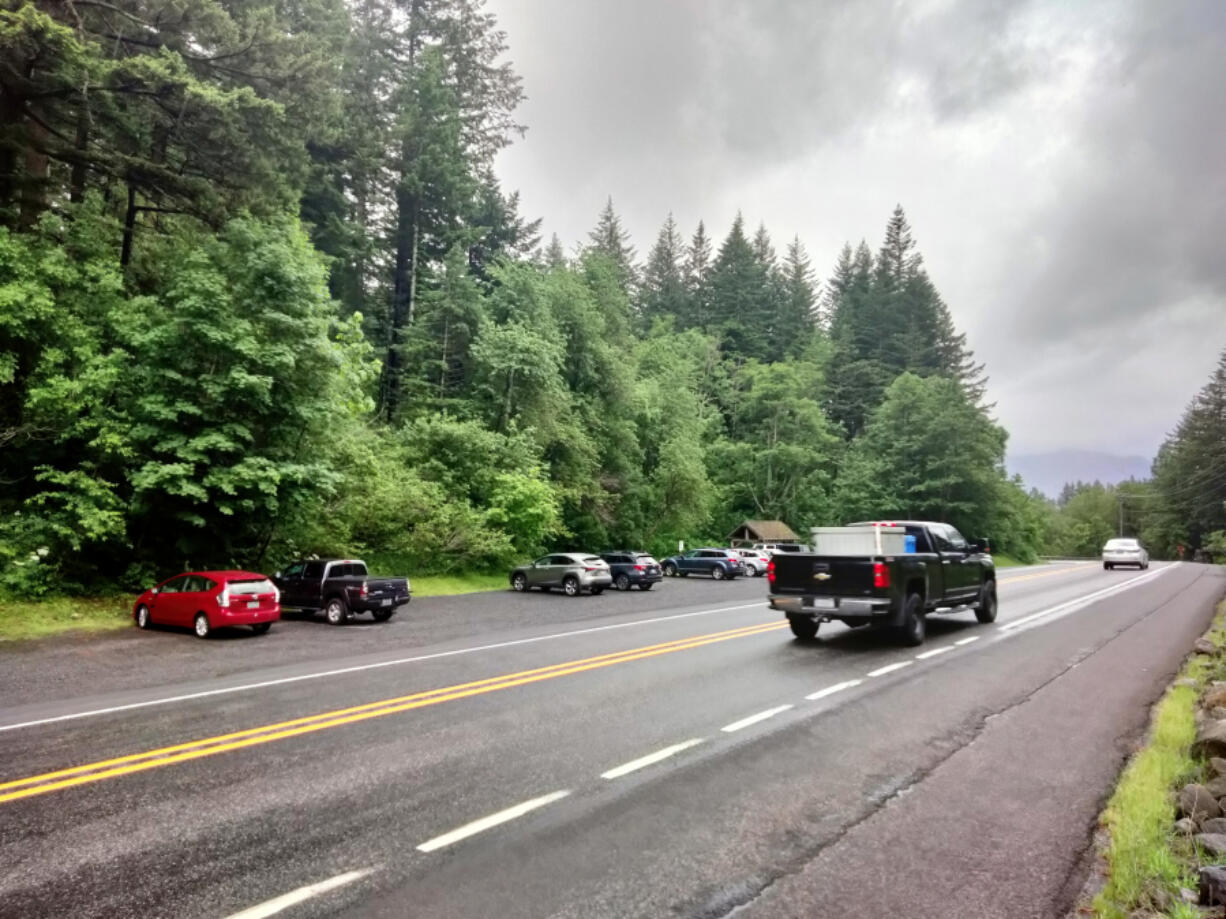 A wide highway shoulder is what passes for a parking lot at the base of Beacon Rock.