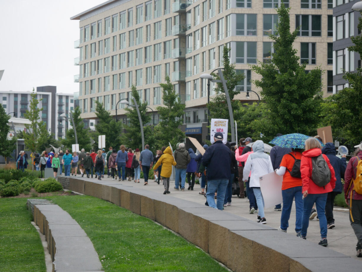 As demonstrators marched around Vancouver Waterfront Park they chanted, "Protect our kids," and, "The NRA has got to go." (Dylan Jefferies/The Columbian)