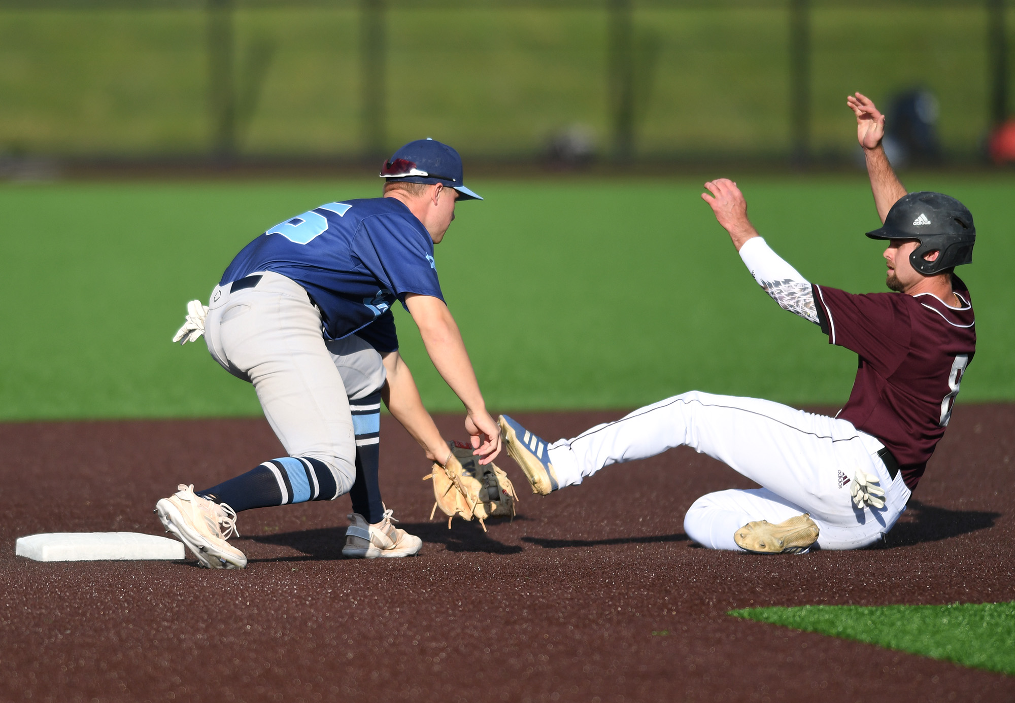 Raptors' Trent Prokes, right, is tagged out by Edmonton shortstop Kelly Corl on Tuesday, June 14, 2022, during a Raptors game against the Edmonton Riverhawks at the Ridgefield Outdoor Recreation Complex.