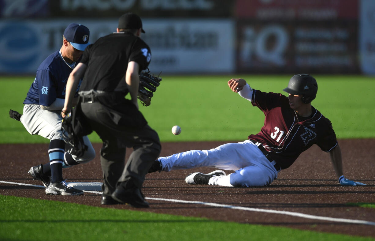 Raptors’ Justin Trimble, right, beats the tag at third base Tuesday, June 14, 2022, during a Raptors game against the Edmonton Riverhawks at the Ridgefield Outdoor Recreation Complex.