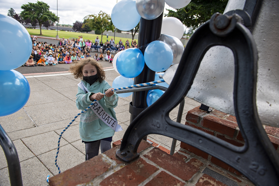 Fifth-grader Connor Clark marks the end of the school year by taking part in the traditional bell-ringing at Hazel Dell Elementary School on Thursday morning.