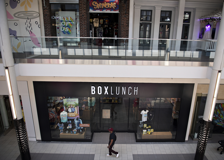 A shopper strolls past BoxLunch, one of two new tenants at Vancouver Mall. The mall is "more than back to normal" following the worst of the coronavirus pandemic, mall managers say.