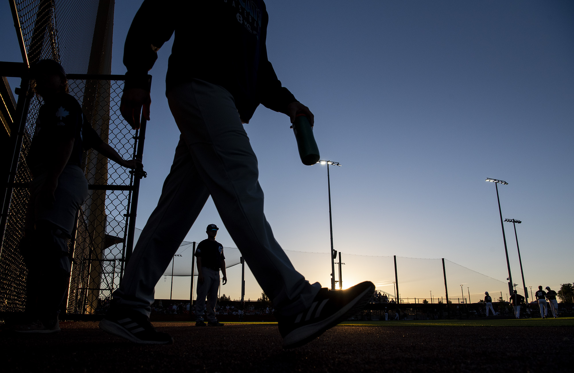 Victoria HarbourCats players walk out of the dugout during sunset Friday, June 24, 2022, during a game between the Ridgefield Raptors and the Victoria HarbourCats at the Ridgefield Outdoor Recreation Complex.