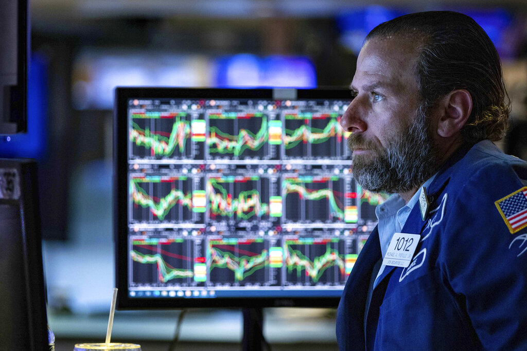 In this photo provided by the New York Stock Exchange, specialist Michael Pistillo works at his post on the trading floor, Wednesday, June 8, 2022. Stocks edged lower in afternoon trading on Wall Street Wednesday and trading remained choppy as investors try to determine how rising interest rates and inflation will impact the economy.