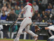 Los Angeles Angels' Mike Trout hits a two-run home run during the seventh inning of the team's baseball game against the Seattle Mariners, Thursday, June 16, 2022, in Seattle. The homer was Trout's second of the game. (AP Photo/Ted S.