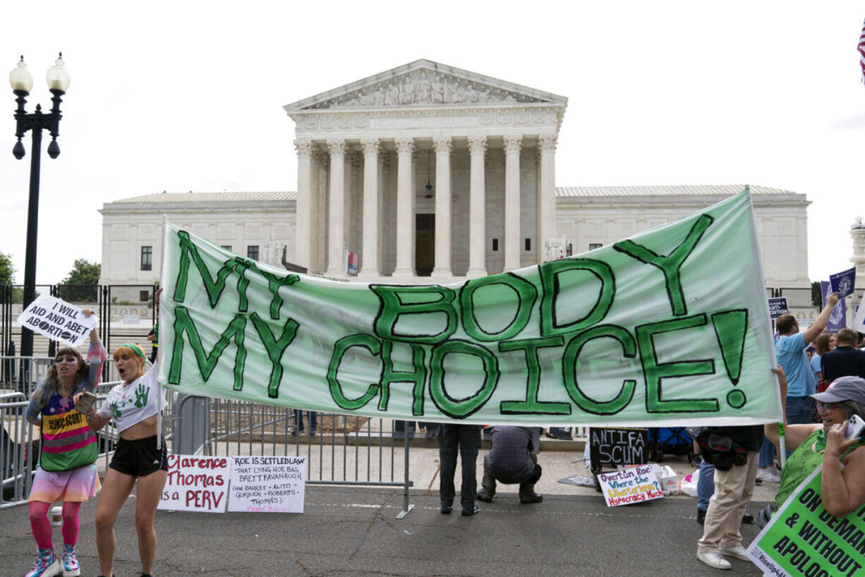 Abortion right activists gather outside the Supreme Court in Washington, Friday, June 24, 2022. The Supreme Court has ended constitutional protections for abortion that had been in place nearly 50 years, a decision by its conservative majority to overturn the court's landmark abortion cases.