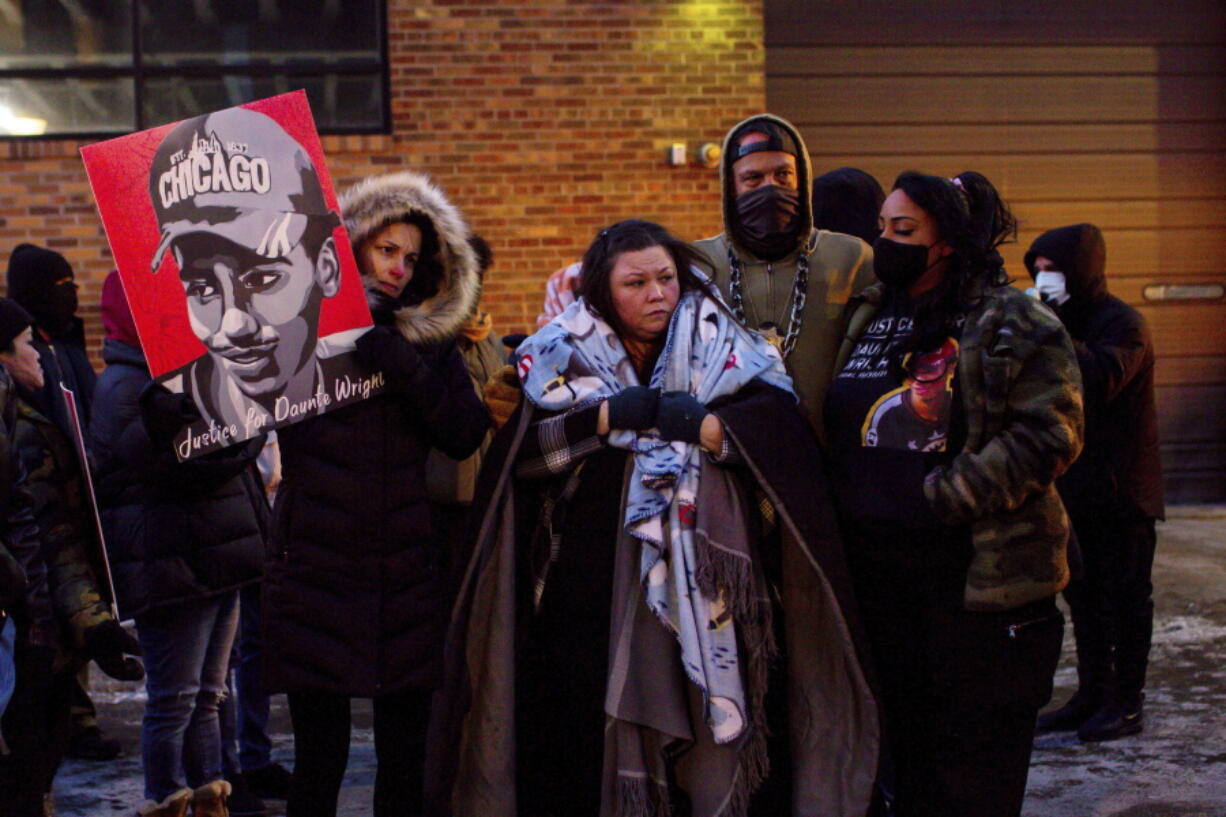 FILE - Katie Bryant, Daunte Wright's mother, is surrounded by community members and activists at the apartment building where activists say Hennepin County Judge Regina Chu lives after former officer Kim Potter was sentenced to two years in prison Friday, Feb. 18, 2022, in Minneapolis.   The suburban Minneapolis city has agreed to pay $3.2 million to the family of Daunte Wright, a Black man who was fatally shot by a police officer who said she confused her gun for her Taser. The tentative settlement also includes changes in police policies and training involving traffic stops like the one that resulted in Wright's death, according to a statement Tuesday, June 21, 2022 from attorneys representing Wright's family.