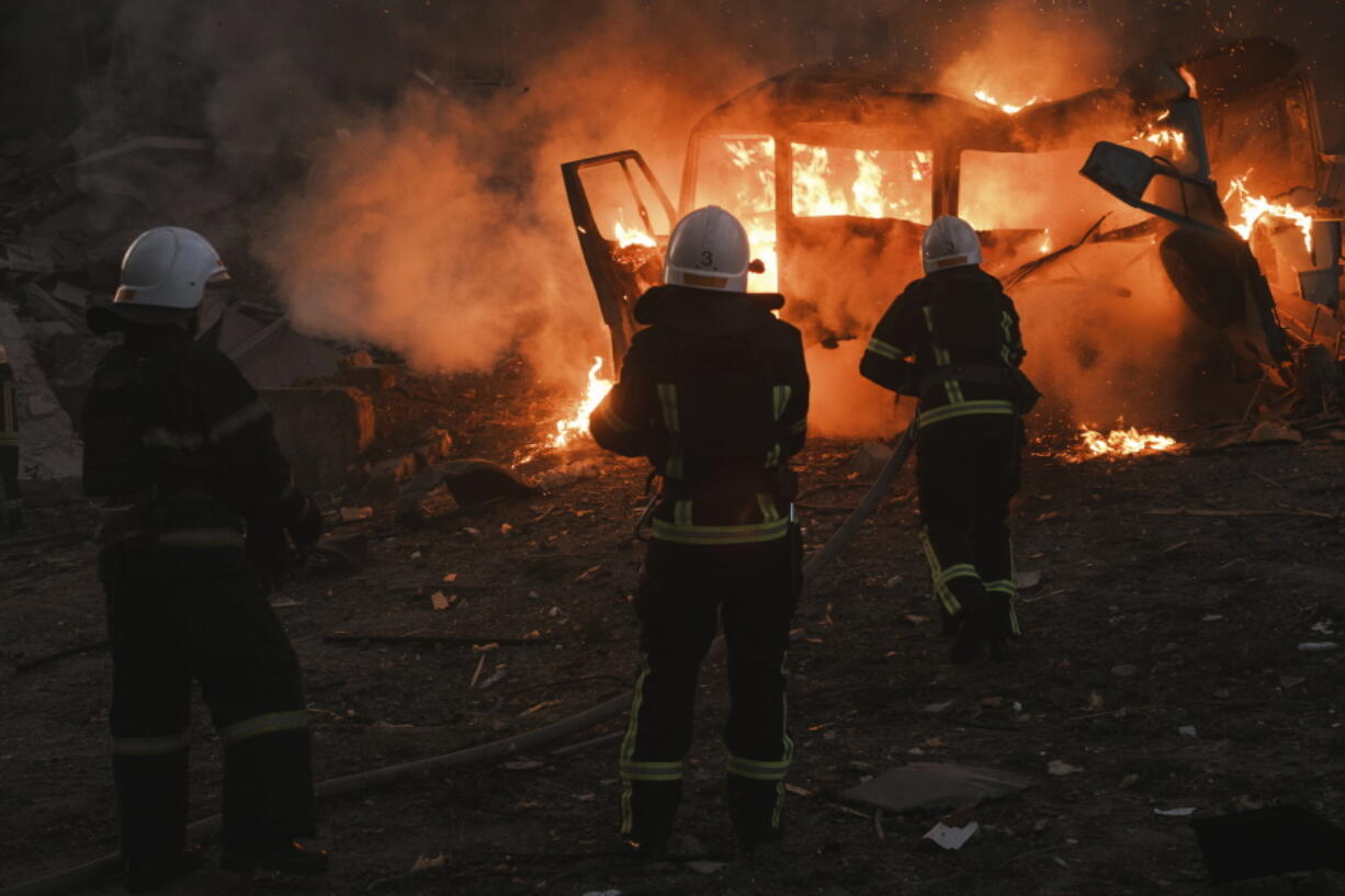 Firefighters work at the site of fire after Russian shelling in Mykolaiv, Ukraine, Saturday, June 18, 2022.
