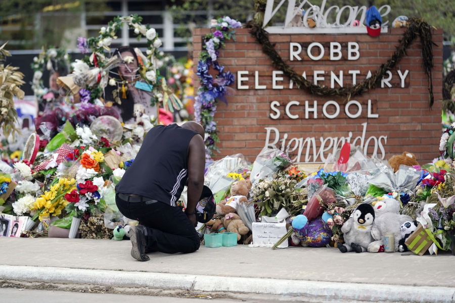 Reggie Daniels pays his respects a memorial at Robb Elementary School, Thursday, June 9, 2022, in Uvalde, Texas, created to honor the victims killed in the recent school shooting. Two teachers and 19 students were killed in the mass shooting.