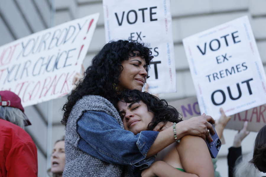 Mitzi Rivas, left, hugs her daughter Maya Iribarren during an abortion-rights protest at City Hall in San Francisco following the Supreme Court's decision to overturn Roe v. Wade, Friday, June 24, 2022. The U.S. Supreme Court's decision to end constitutional protections for abortion has cleared the way for states to impose bans and restrictions on abortion -- and will set off a series of legal battles.