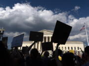 FILE - Abortion-rights activists protest outside the Supreme Court in Washington, Saturday, June 25, 2022. The Supreme Court's ruling allowing states to regulate abortion has set off a mad travel scramble across the country to direct patients to states that still allow the procedure.