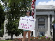 FILE - Abortion-rights demonstrator Jessica Smith holds a sign in front of the Hamilton County Court House on May 14, 2022, in Chattanooga, Tenn. A federal court on Tuesday, June 28, 2022, allowed Tennessee's ban on abortion as early as six weeks into pregnancy to take effect, citing the Supreme Court's decision last week to overturn the landmark Roe v. Wade abortion rights case.