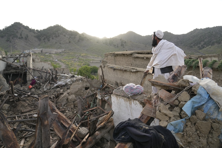 A man stands among destruction after an earthquake in Gayan village, in Paktika province, Afghanistan, Thursday, June 23, 2022. A powerful earthquake struck a rugged, mountainous region of eastern Afghanistan early Wednesday, flattening stone and mud-brick homes in the country's deadliest quake in two decades, the state-run news agency reported.