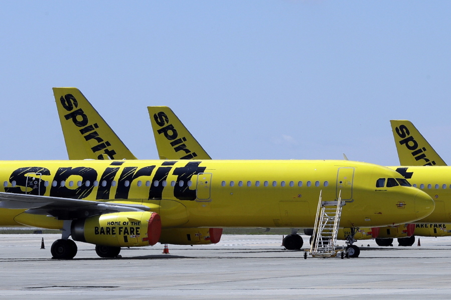 FLE - A line of Spirit Airlines jets sit on the tarmac at the Orlando International Airport on May 20, 2020, in Orlando, Fla.  Shareholders of Spirit Airlines will vote Thursday, June 29, 2022, on a proposed merger with Frontier Airlines, and the outcome could affect fares for millions of air travelers who depend on the budget airlines.