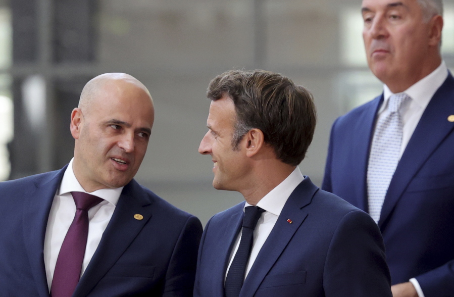 FILE - North Macedonia's Prime Minister Dimitar Kovacevski, left, speaks with French President Emmanuel Macron as they walk to a group photo during an EU summit in Brussels, on June 23, 2022. Bulgaria's parliament has voted to lift a veto that has long blocked European Union membership negotiations with North Macedonia and Albania. The move raises fresh hopes that the bloc can now press on with its expansion plans in the Western Balkans amid Russia's war in Ukraine. France made last-ditch efforts this week to resolve an ethnic and cultural dispute between Bulgaria and North Macedonia that was the source of the veto.