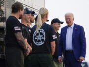 FILE - President Joe Biden greets firefighters as he tours the National Interagency Fire Center, Sept. 13, 2021, in Boise, Idaho. Biden on June 21, 2022, signed off on giving federal wildland firefighters a hefty raise for the next two fiscal years, a move that comes as much of the West is bracing for a difficult wildfire season.