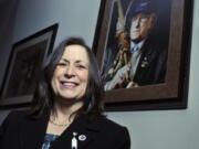 FILE - Marilynn "Lynn" Malerba stands next to a photograph of late Chief Ralph Sturges at Tribal offices in Uncasville, Conn., on March 4, 2010. Malerba, who is Native American, was nominated to be U.S. Treasurer in a historic first, Tuesday, June 21, 2022. Biden's nomination of Malerba to the federal Treasury role was announced ahead of Treasury Secretary Janet Yellen's visit to the Rosebud Indian Reservation in South Dakota, Tuesday.
