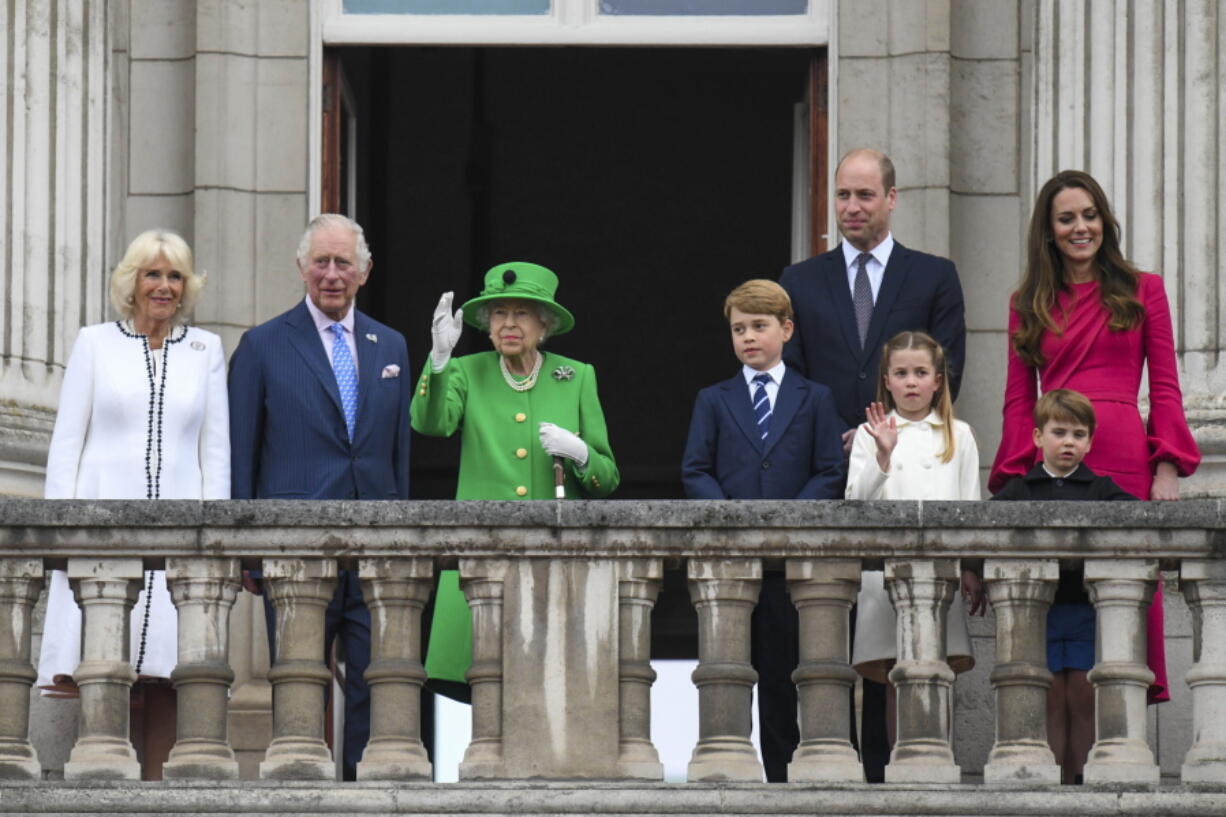 From left,  Camilla, Duchess of Cornwall Prince Charles, Queen Elizabeth II, Prince George, Prince William, Princess Charlotte, Prince Louis and Kate, Duchess of Cambridge stand on the balcony, at the end of the Platinum Jubilee Pageant held outside Buckingham Palace, in London, Sunday June 5, 2022, on the last of four days of celebrations to mark the Platinum Jubilee. The pageant will be a carnival procession up The Mall featuring giant puppets and celebrities that will depict key moments from Queen Elizabeth II's seven decades on the throne.