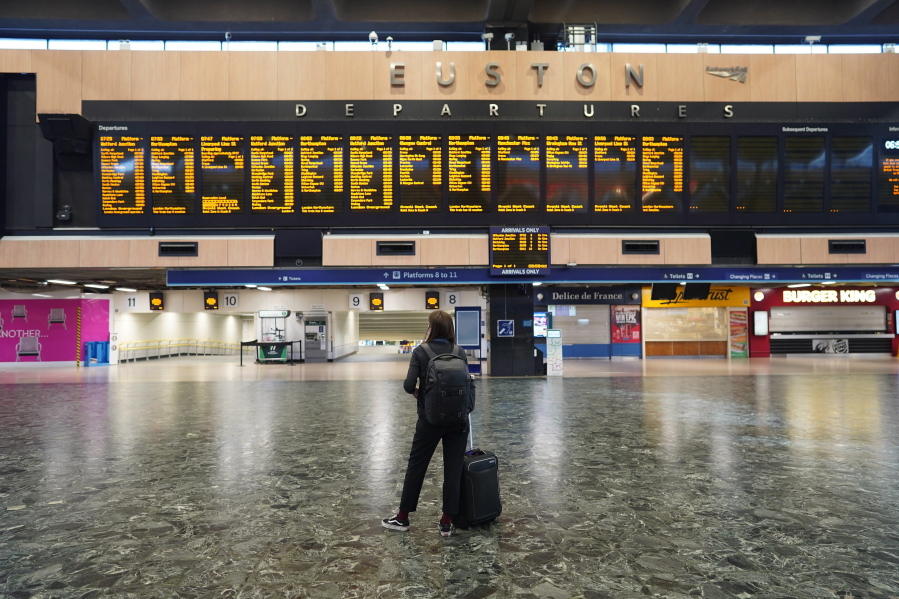 A passenger at Euston station in London looks at the departures board on the first day of a rail strike on Tuesday June 21, 2022. Britain's biggest rail strikes in decades went ahead Tuesday after last-minute talks between a union and train companies failed to reach a settlement over pay and job security. Up to 40,000 cleaners, signalers, maintenance workers and station staff are due to walk out for three days this week, on Tuesday, Thursday and Saturday.