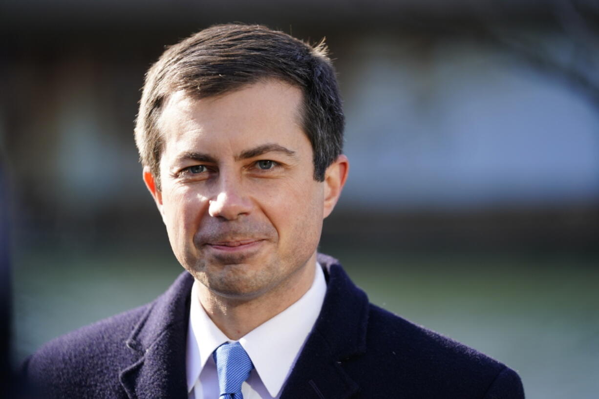 FILE - Transportation Secretary Pete Buttigieg listens at an event in Philadelphia, on Jan. 14, 2022. Buttigieg is launching a $1 billion pilot program aimed at helping reconnect cities and neighborhoods racially segregated or divided by road projects. He promises wide-ranging help to dozens of communities despite the program's limited dollars.