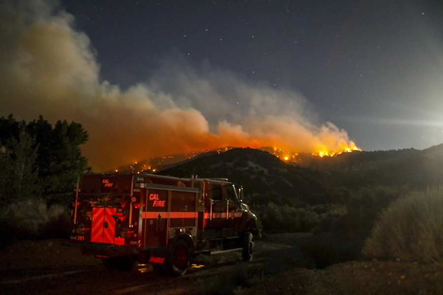 A fire engine is seen as the Sheep fire burns in Wrightwood, Calif., Monday, June 13, 2022. (AP Photo/Ringo H.W.