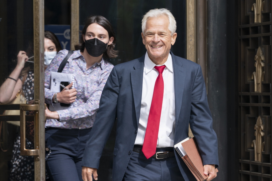 Former Trump White House official Peter Navarro smiles as he leaves federal court, Friday, June 3, 2022, in Washington. Navarro was indicted Friday on contempt charges after defying a subpoena from the House panel investigating the Jan. 6 attack on the U.S. Capitol.