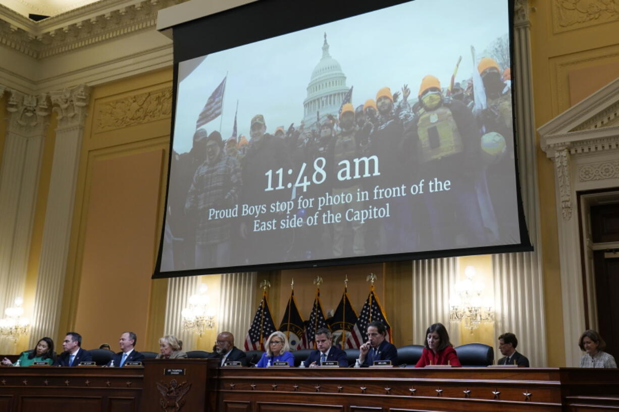A video is shown the committee claims shows Proud Boys in front of the Capitol on Jan. 6th, as committee members from left to right, Rep. Stephanie Murphy, D-Fla., Rep. Pete Aguilar, D-Calif., Rep. Adam Schiff, D-Calif., Rep. Zoe Lofgren, D-Calif., Chairman Bennie Thompson, D-Miss., Vice Chair Liz Cheney, R-Wyo., Rep. Adam Kinzinger, R-Ill., Rep. Jamie Raskin, D-Md., and Rep. Elaine Luria, D-Va., look on, as the House select committee investigating the Jan. 6 attack on the U.S. Capitol holds its first public hearing to reveal the findings of a year-long investigation, at the Capitol in Washington, Thursday, June 9, 2022. (AP Photo/J.