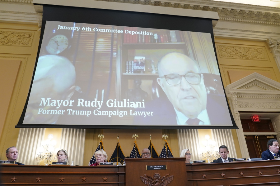 FILE - A video deposition of former Trump campaign attorney and former New York Mayor Rudolph Giuliani plays as the House select committee investigating the Jan. 6 attack on the U.S. Capitol continues to reveal its findings of a year-long investigation, at the Capitol in Washington, Monday, June 13, 2022.