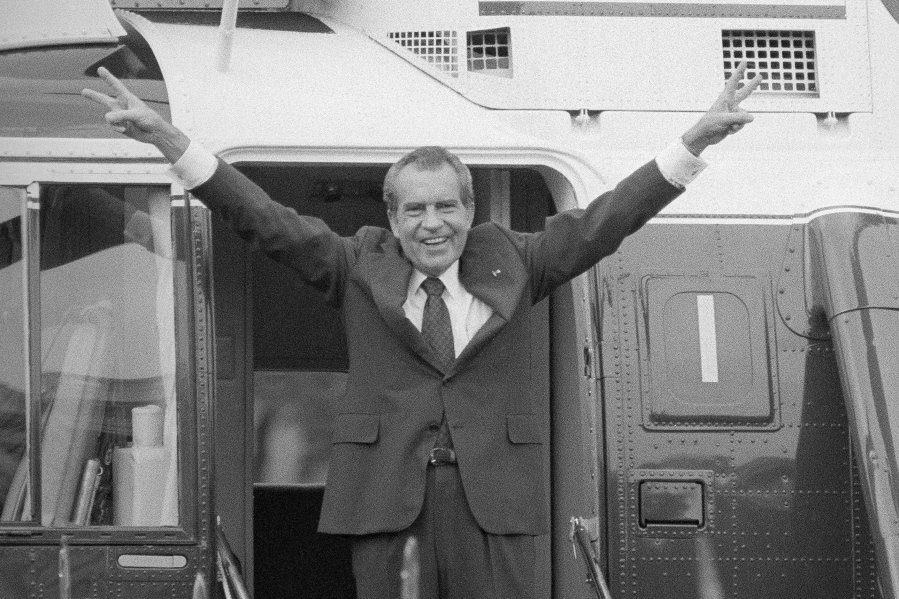FILE - Richard Nixon says goodbye with a victorious salute to his staff members outside the White House as he boards a helicopter after resigning the presidency on Aug. 9, 1974. The traumas of Watergate and Jan. 6 are a half century apart, in vastly different eras, and they were about different things. But in both episodes, a president tried to do an end run around democracy. Friday is the 50th anniversary of the Watergate break-in that eventually consumed Richard Nixon's presidency.