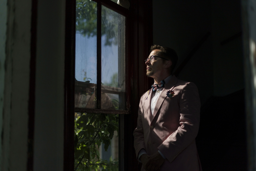 Scout, a transgender man who uses one name, stands in the entrance to his home in Providence, R.I., Wednesday, June 8, 2022. The 2020 census questionnaire drove Scout crazy. With no direct questions about sexual orientation and gender identity, it made him feel invisible, not worth including in the U.S. head count.